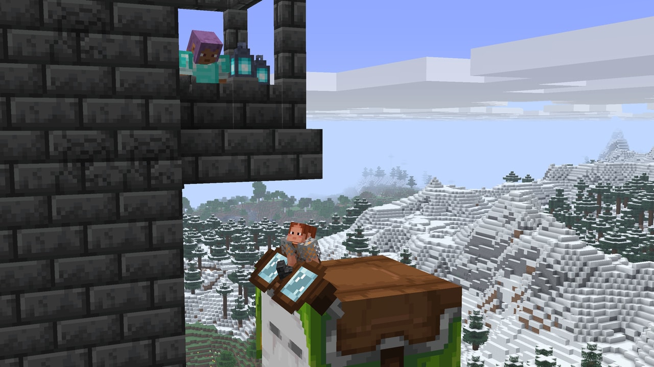 Ari and Efe building a castle. Ari is standing on a Happy Ghast, using it to place blocks under the balcony.