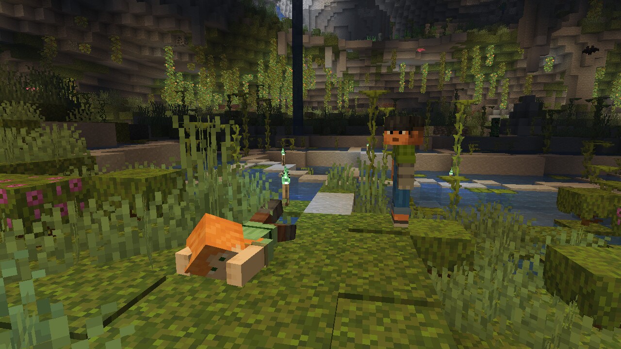Mannequins of Alex and Sunny, swimming and standing up respectively, can be seen inside a Lush Cave.