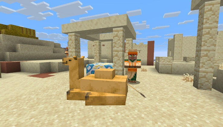 A Camel is laying in a Desert Village. There's a Villager next to it.